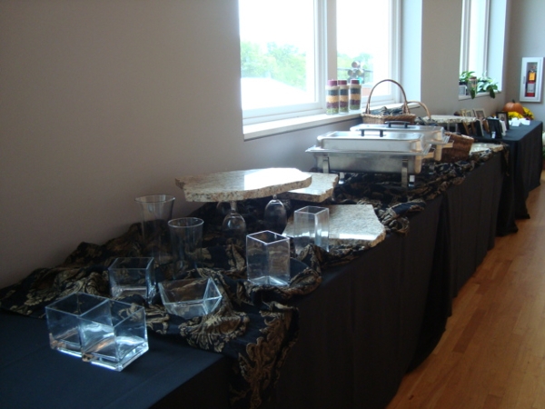 A reception table full of food set up as a buffet